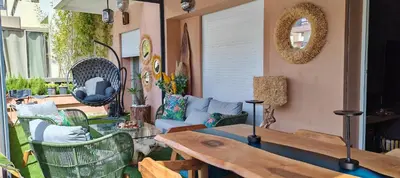 a patio with a couch and a table at Whispers of NATURE in Marrakech