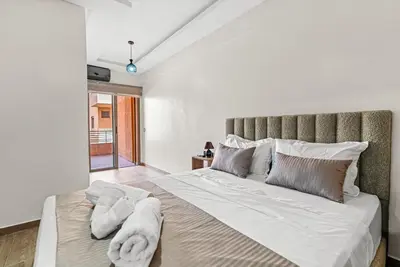 a bedroom with a large bed with towels on it at Écrin Soleil proche Guéliz et sécurisé in Marrakech