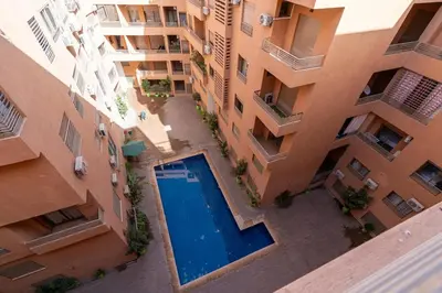 an overhead view of an apartment complex with a swimming pool at Écrin Soleil proche Guéliz et sécurisé in Marrakech