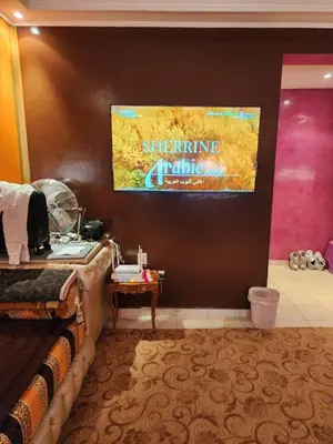 a room with a bed and a painting on the wall at Comfortable apartment for families in Marrakech