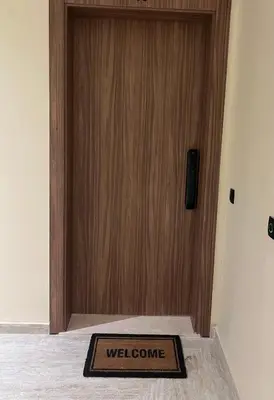 a welcome mat in front of a wooden door at Rahma Apartment in Marrakech