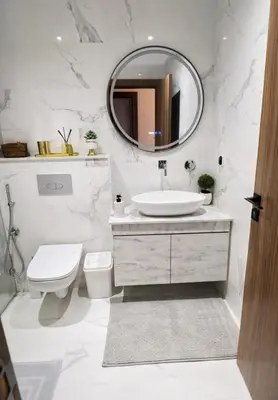 a bathroom with a sink and a toilet and a mirror at Rahma Apartment in Marrakech