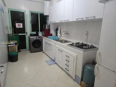 a kitchen with a sink and a stove in it at Bright 2-BR - Balcony & Parking - Fast Wi-Fi - Near Route de Casa in Marrakech