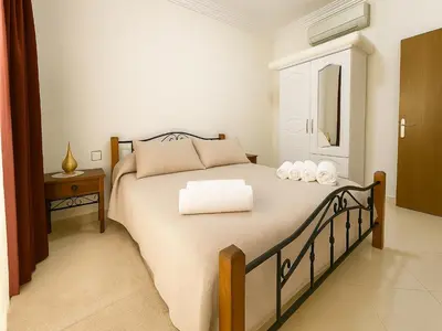 a bedroom with a bed with two towels on it at Bright 2-BR - Balcony & Parking - Fast Wi-Fi - Near Route de Casa in Marrakech