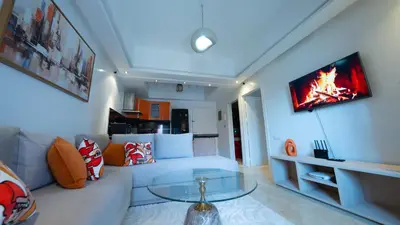 a living room with a white couch with a glass table at Chic City Studio in Marrakech in Marrakech