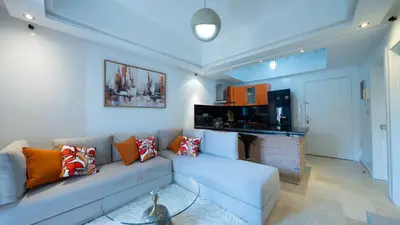 a living room with a couch and a kitchen at Chic City Studio in Marrakech in Marrakech