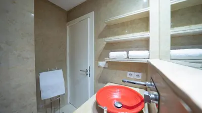 a bathroom with a red sink on a counter at Chic City Studio in Marrakech in Marrakech