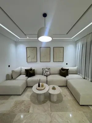 a living room with a couch and a table at Menara Garden - 3 Ch - Piscine - 2 min de M Avenue in Marrakech