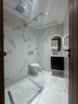 a bathroom with a shower and a toilet and a mirror at Menara Garden - 3 Ch - Piscine - 2 min de M Avenue in Marrakech
