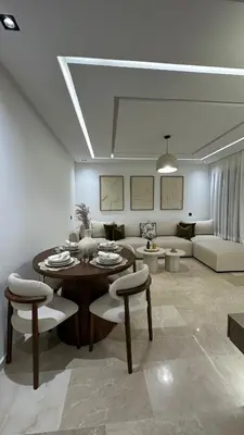 a living room with a table and a couch at Menara Garden - 3 Ch - Piscine - 2 min de M Avenue in Marrakech