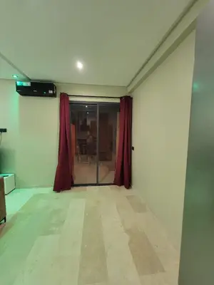 an empty room with red curtains and a glass door at Modern Apartment with Pools & Free Parking in Marrakech
