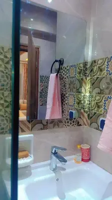 a bathroom with a sink and a mirror at Appartement,kech in Marrakech