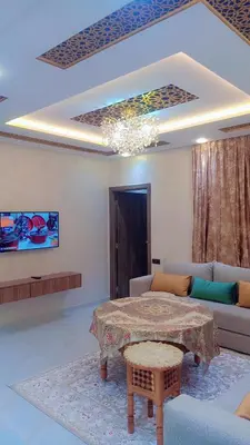 a living room with a table and a couch at Appartement,kech in Marrakech