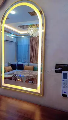 a mirror in a room with a couch and a table at Appartement,kech in Marrakech