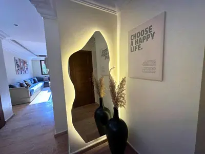 two black vases sitting in a hallway with a mirror at Appartement de Luxe avec Piscine et Jacuzzi Marrakech in Marrakech