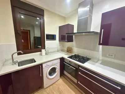 a kitchen with a sink and a washing machine at Appartement de Luxe avec Piscine et Jacuzzi Marrakech in Marrakech