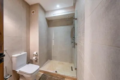 a bathroom with a shower and a toilet in it at L'Elara - Semlalia - Duplex - Piscine in Marrakech