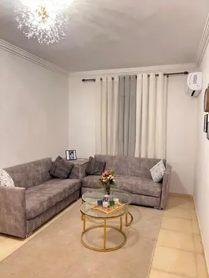 a living room with a couch and a table at New, quiet and comfortable in Marrakech