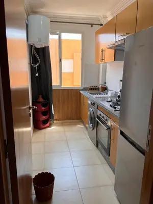 a kitchen with a refrigerator and a stove at New, quiet and comfortable in Marrakech