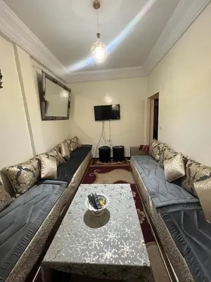 a living room with a couch and a table at Dar wafa in Marrakech