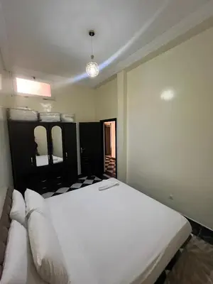 a bedroom with a large white bed with two pillows at Dar wafa in Marrakech