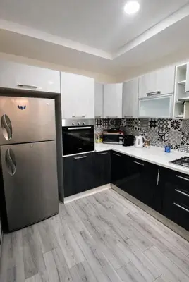 a kitchen with a stainless steel refrigerator in it at Très bel Riad avec piscine au cœur de Marrakech in Marrakech