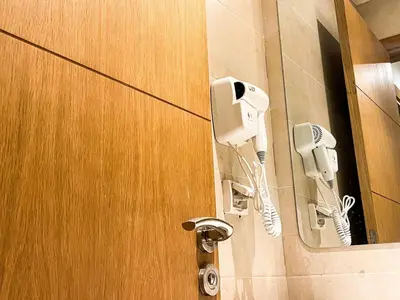 a bathroom door with a hair dryer and a phone at Elegant 3-Bedroom Duplex Downtown Private Terrace in Marrakech
