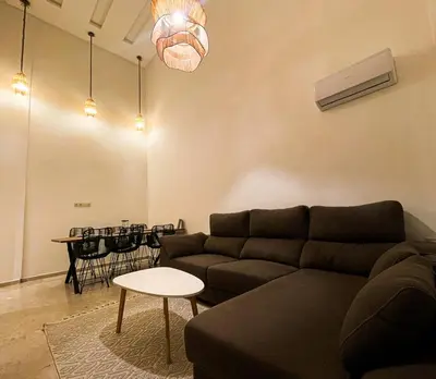 a living room with a couch and a table at Elegant 3-Bedroom Duplex Downtown Private Terrace in Marrakech