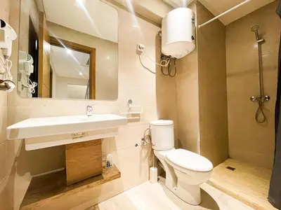 a bathroom with a toilet and a sink at Elegant 3-Bedroom Duplex Downtown Private Terrace in Marrakech