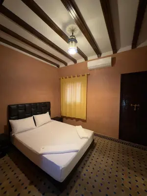 a bedroom with a large bed in a room at Authentic Moroccan Riad with a pool and a rooftop in Marrakech