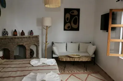 a living room with a couch and a fireplace at Riad Dar Familya in Marrakech