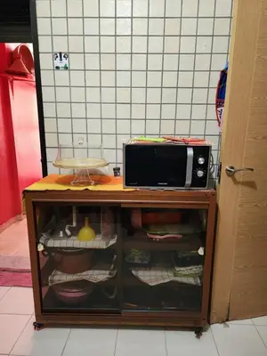 a microwave oven sitting on top of a cabinet at Comfortable apartment for families in Marrakech