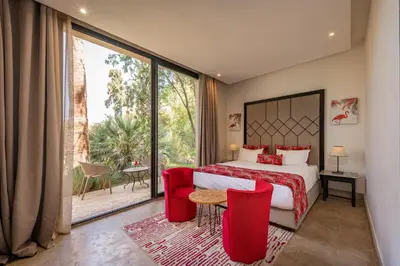 a hotel room with a bed and a large window at 2 Superbe villas avec chacune piscine privée & jardin 5 ou 6 chambres in Marrakech