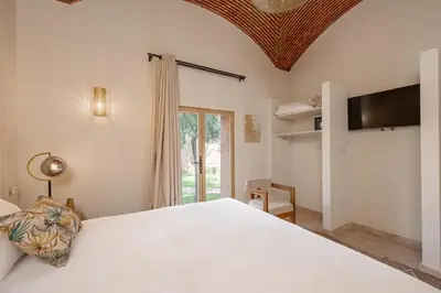 a bedroom with a large white bed and a window at 2 Superbe villas avec chacune piscine privée & jardin 5 ou 6 chambres in Marrakech