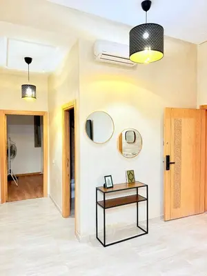 a hallway with a table and a door at N1 Moderne Confortable FAMILY Près De Gueliz in Marrakech