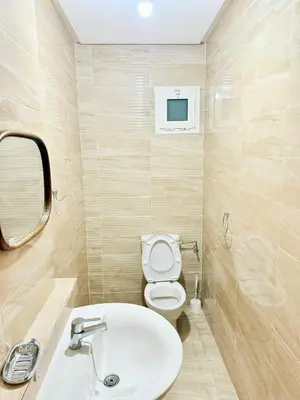 a bathroom with a white sink and a toilet at N1 Moderne Confortable FAMILY Près De Gueliz in Marrakech