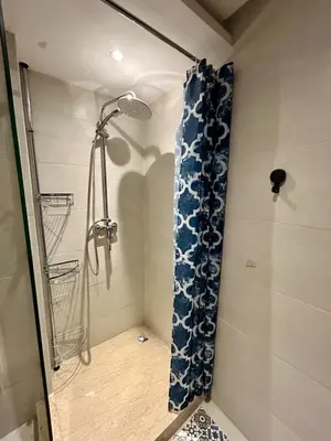 a shower with a blue shower curtain in a bathroom at New! Nouveau! Le Cocon familial in Marrakech