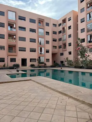 a large building with a swimming pool in front of it at New! Nouveau! Le Cocon familial in Marrakech
