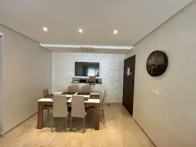 a kitchen and dining room with a table and chairs at New! Nouveau! Le Cocon familial in Marrakech