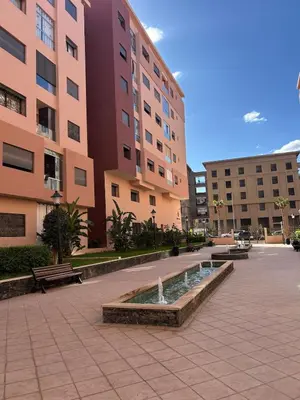 a courtyard with a fountain in front of a building at New! Nouveau! Le Cocon familial in Marrakech