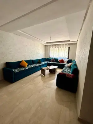 a living room with a blue couch and a table at New! Nouveau! Le Cocon familial in Marrakech