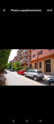 two pictures of cars parked on a city street at Le Palmier de Guéliz in Marrakech