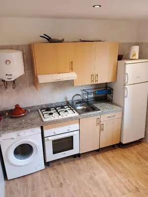 a kitchen with a stove and a washing machine at Le Palmier de Guéliz in Marrakech