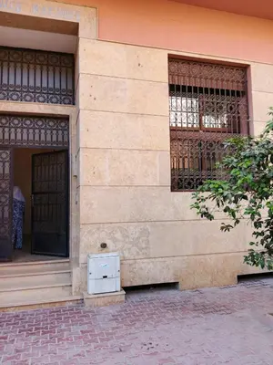 a building with a gate and a box on the side at Le Palmier de Guéliz in Marrakech
