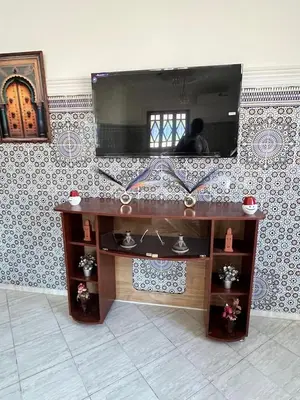 a wooden table with a mirror on a wall at Beautiful, very quiet apartment in Marrakech