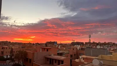 a view of a city at sunset at Kueerland in Marrakech