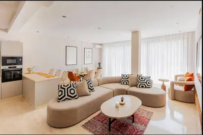 a living room with a couch and a table at Villa Dar Moumoune à Marrakech, piscine chauffée en option in Sraghna