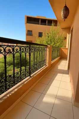 a balcony with a black fence and a tile floor at Studio cosy Centre ville à 4 min et stade à 6 min in Marrakech