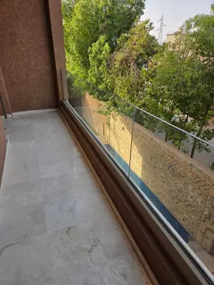 a balcony with a view of a wall and trees at Villa targa prestige in Marrakech