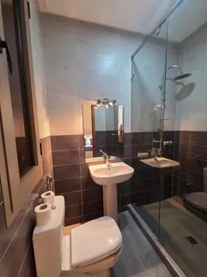 a bathroom with a toilet and a sink and a shower at Villa targa prestige in Marrakech